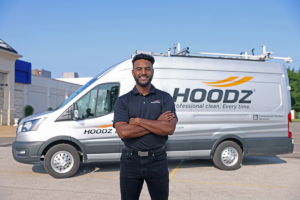 HOODZ technician standing in front of HOODZ van