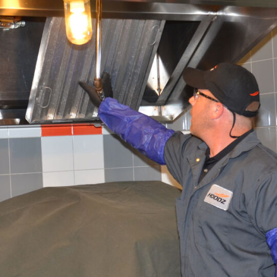 Hoodz technician performing vent hood filter cleaning