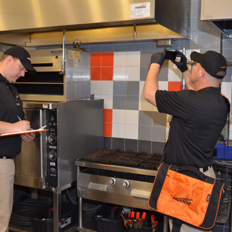 HOODZ technician performing a commercial conveyor oven cleaning service