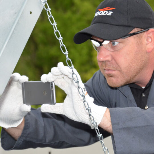 HOODZ technician inspecting an exhaust vent