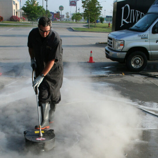 HOODZ technician providing professional concrete cleaning service