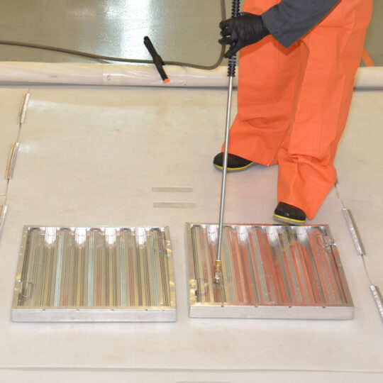 Cleaning commercial kitchen grates with a power washer