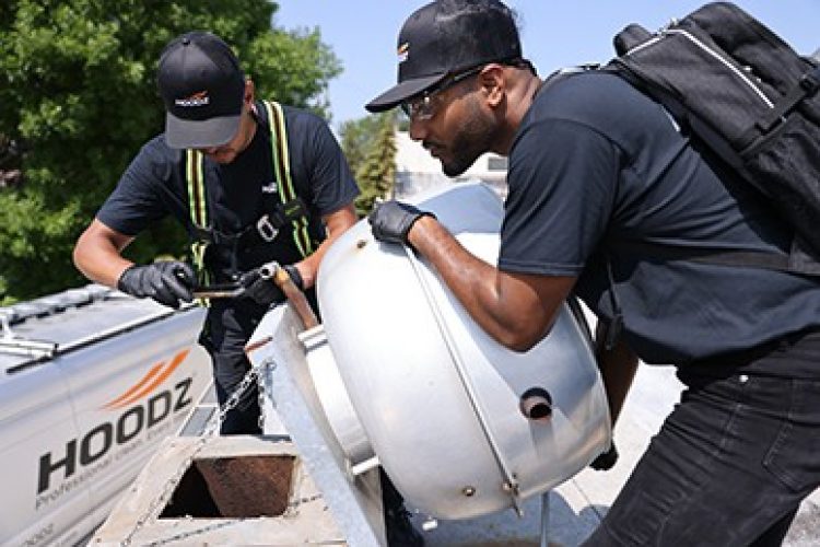 Hoodz workers replacing hood fan on a roof